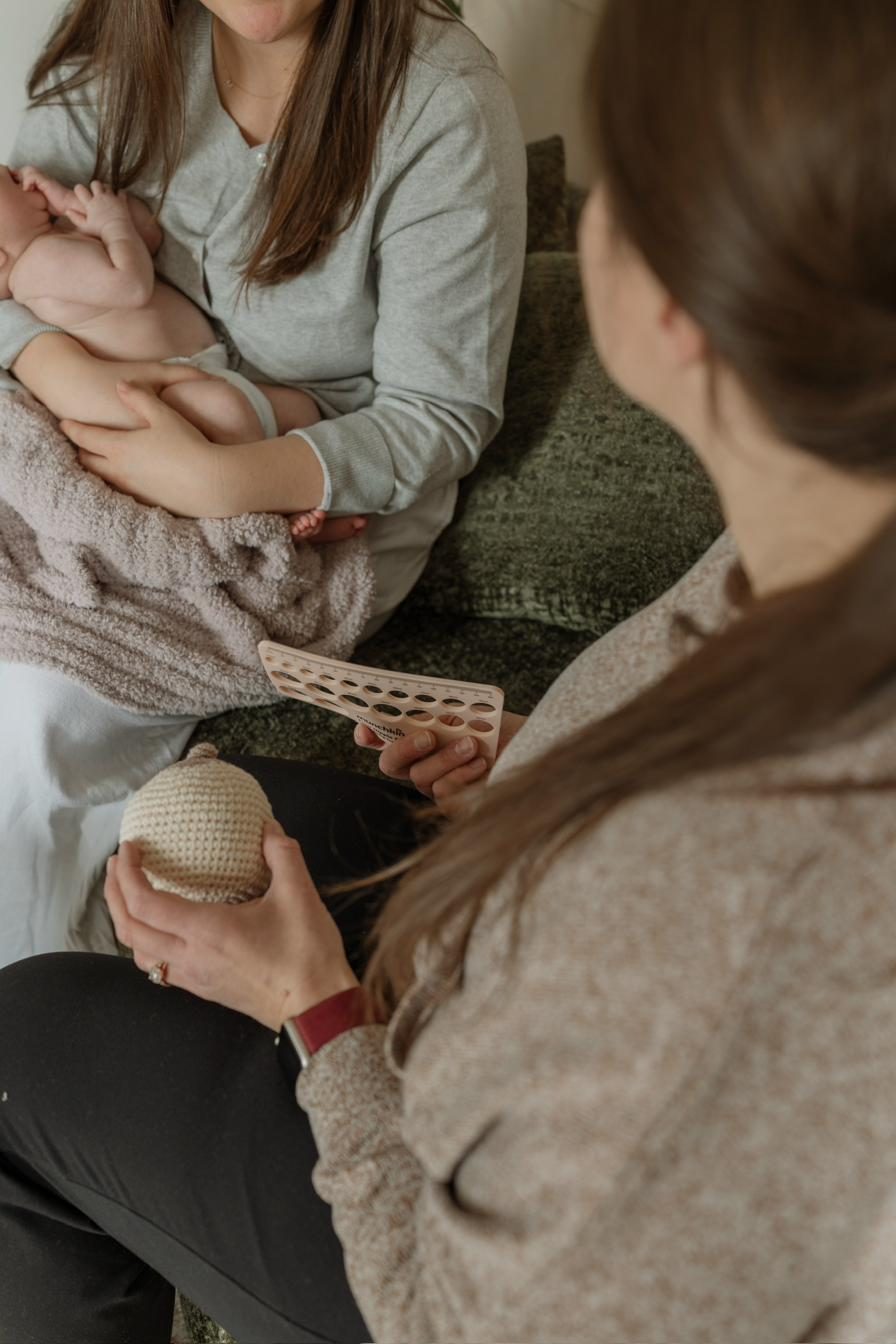 Kourtney providing lactation support to a nursing mother