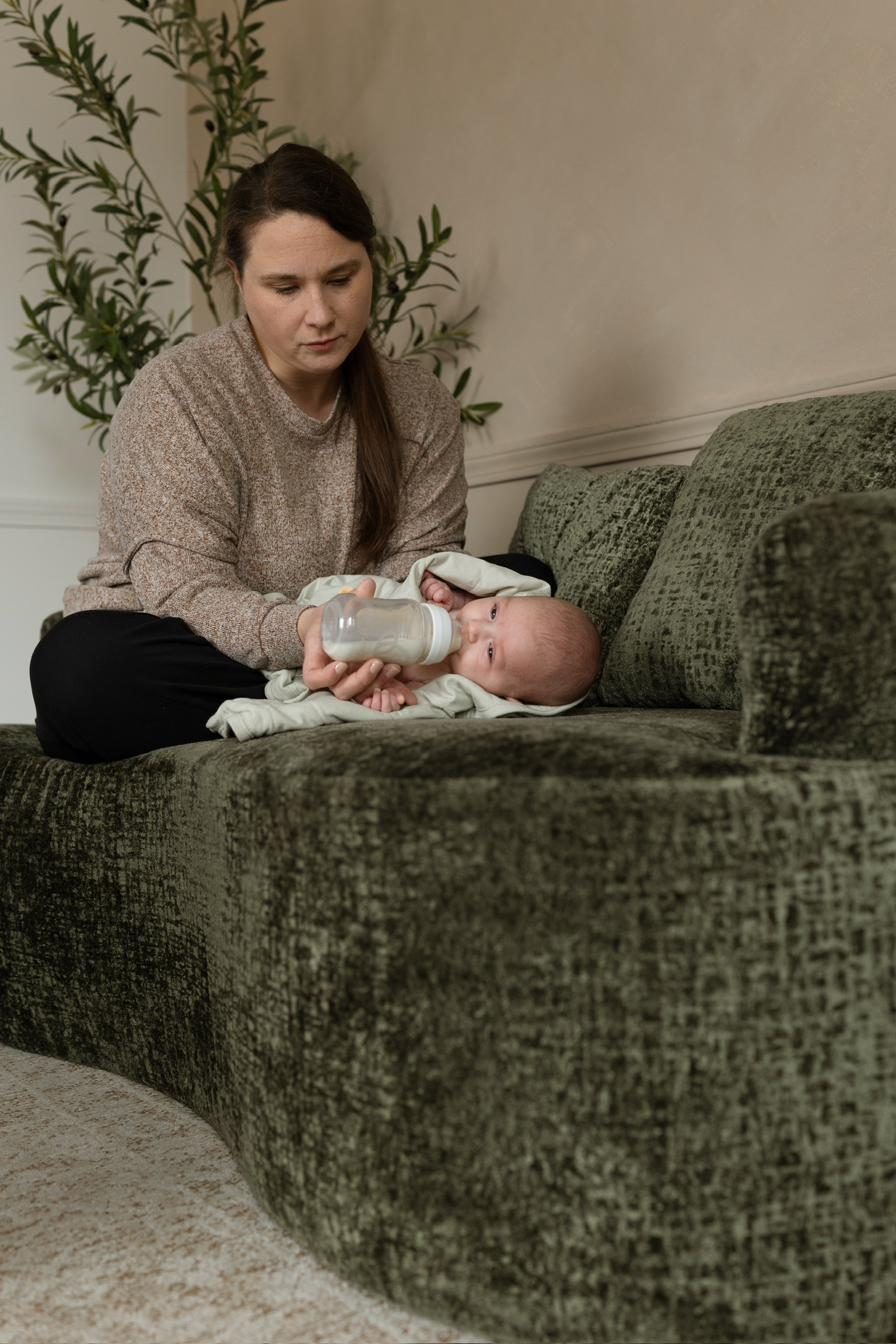 Kourtney feeding a baby during an overnight shift