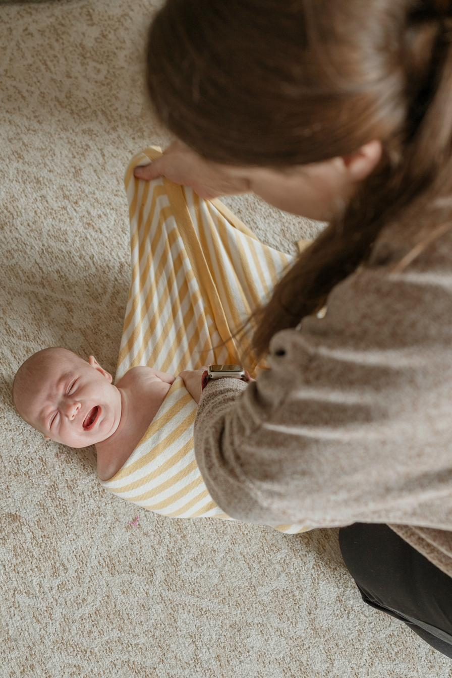 Newborn being swaddled